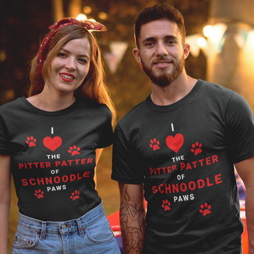 One man and one woman posing for a photo wearing T-Shirts from the 